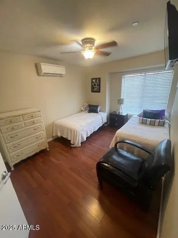 a living room with furniture a dining table and a chandelier