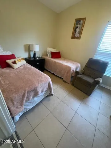 a living room with furniture a dining table and a chandelier