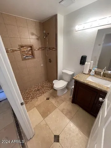 a bedroom with a bed and a couch