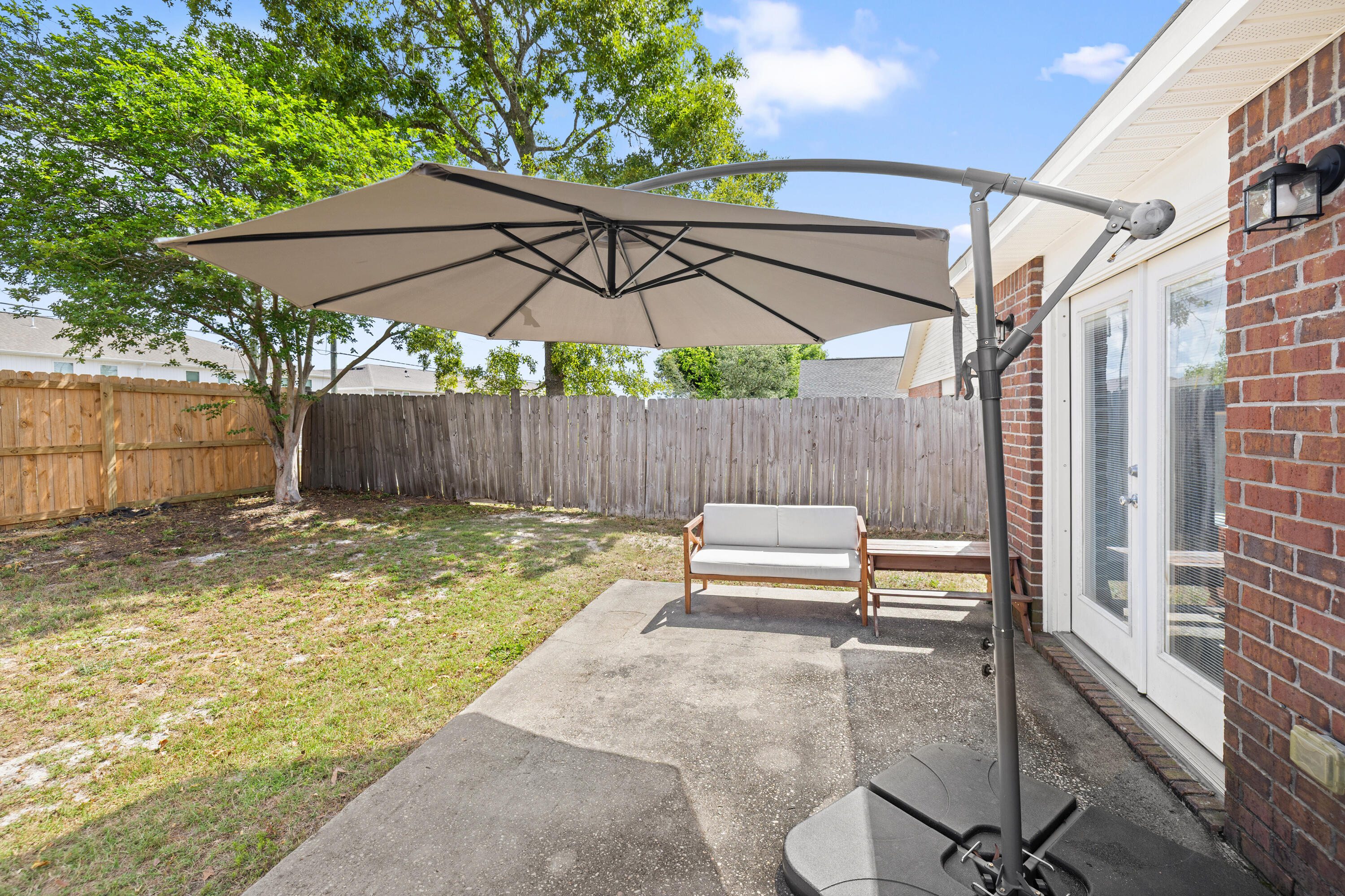 202 Limestone Circle Crestview, FL 32539 - Photo 35 of 49 a backyard of a house with a garden and outdoor seating