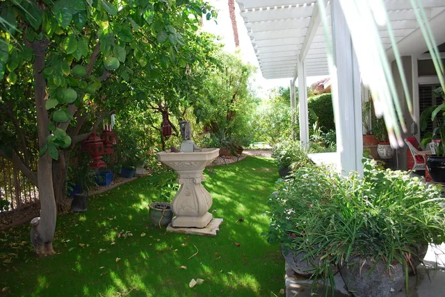 a view of a fountain in the backyard of the house