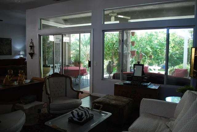 a living room with furniture and a floor to ceiling window