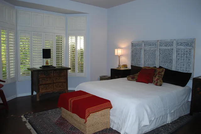 a bedroom with a bed and a dresser