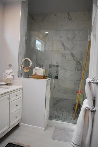 a bathroom with a sink a toilet and shower