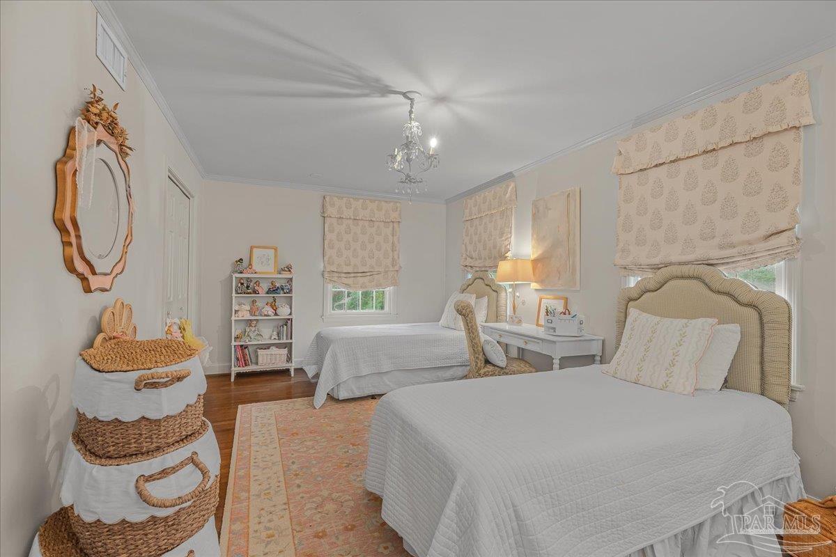 3361 Palermo Road Pensacola, FL 32503 - Photo 43 of 50 a bedroom with a bed and a chandelier