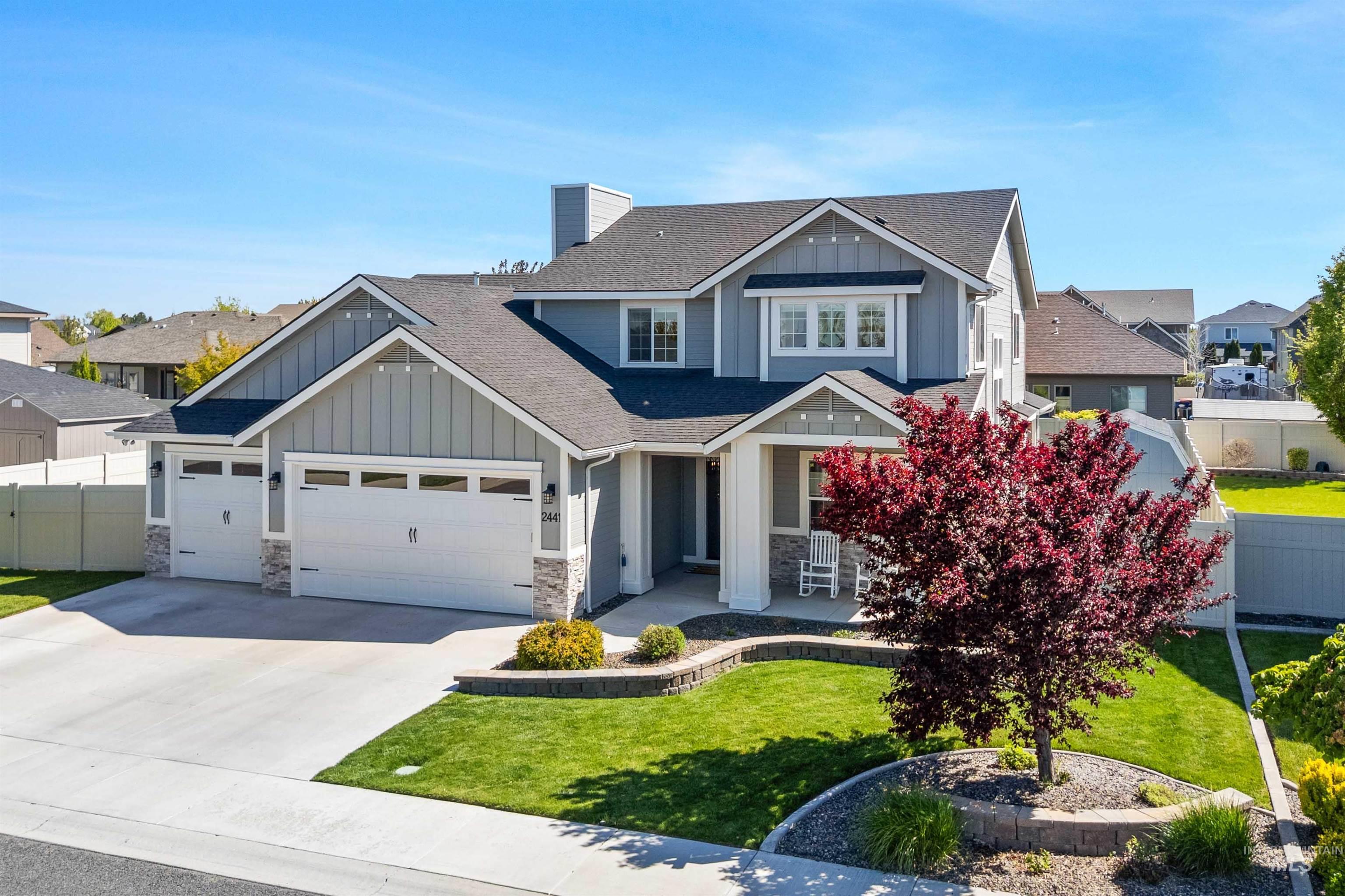 2441 Blick Lane Twin Falls, ID 83301 - Photo 1 of 50 Modern two-story residence featuring a two-car garage, gray horizontal siding, and board-and-batten gables