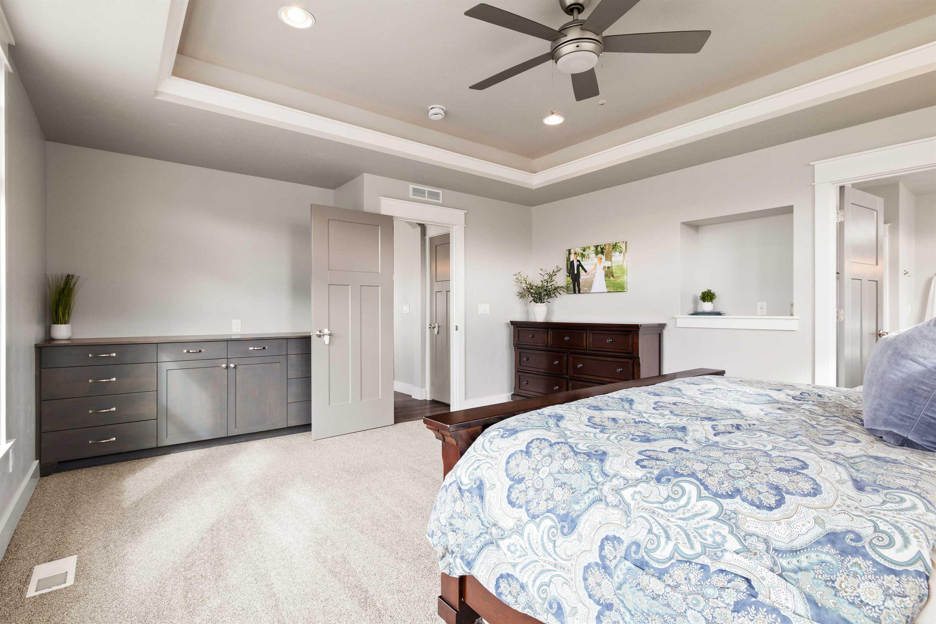 2441 Blick Lane Twin Falls, ID 83301 - Photo 15 of 50 Bedroom with a tray ceiling, recessed lighting, light colored carpet, and a ceiling fan