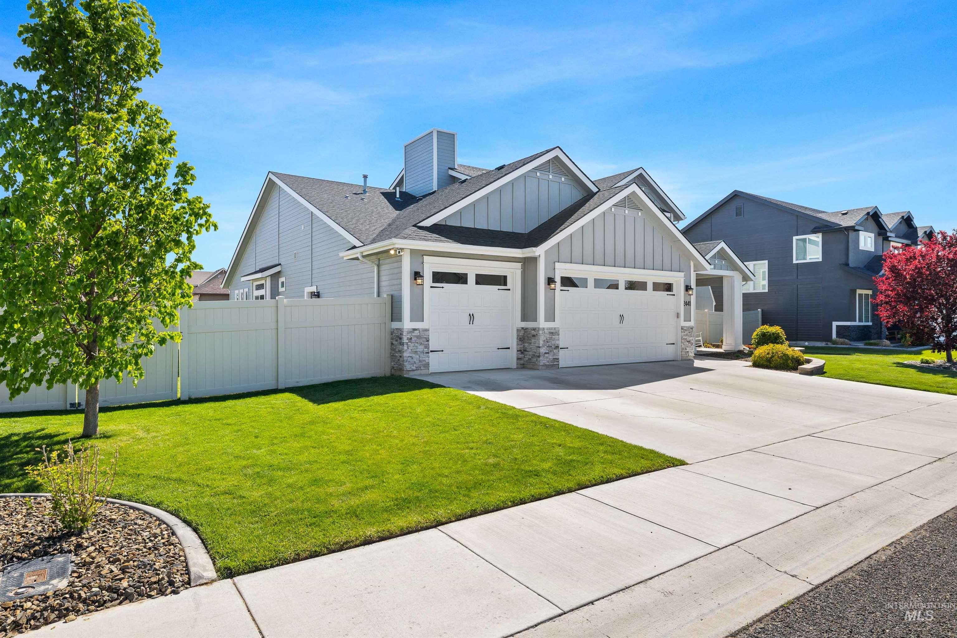 2441 Blick Lane Twin Falls, ID 83301 - Photo 43 of 50 Contemporary ranch-style home featuring a two-car garage, gray siding with board and batten accents, and stone veneer detailing