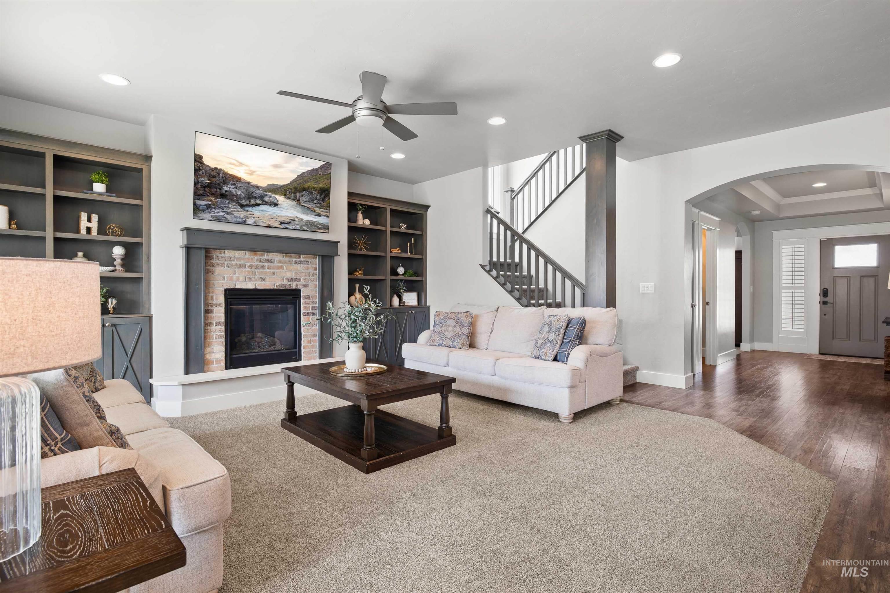 2441 Blick Lane Twin Falls, ID 83301 - Photo 7 of 50 Living room with arched walkways, wood finished floors, a fireplace, ceiling fan, and recessed lighting
