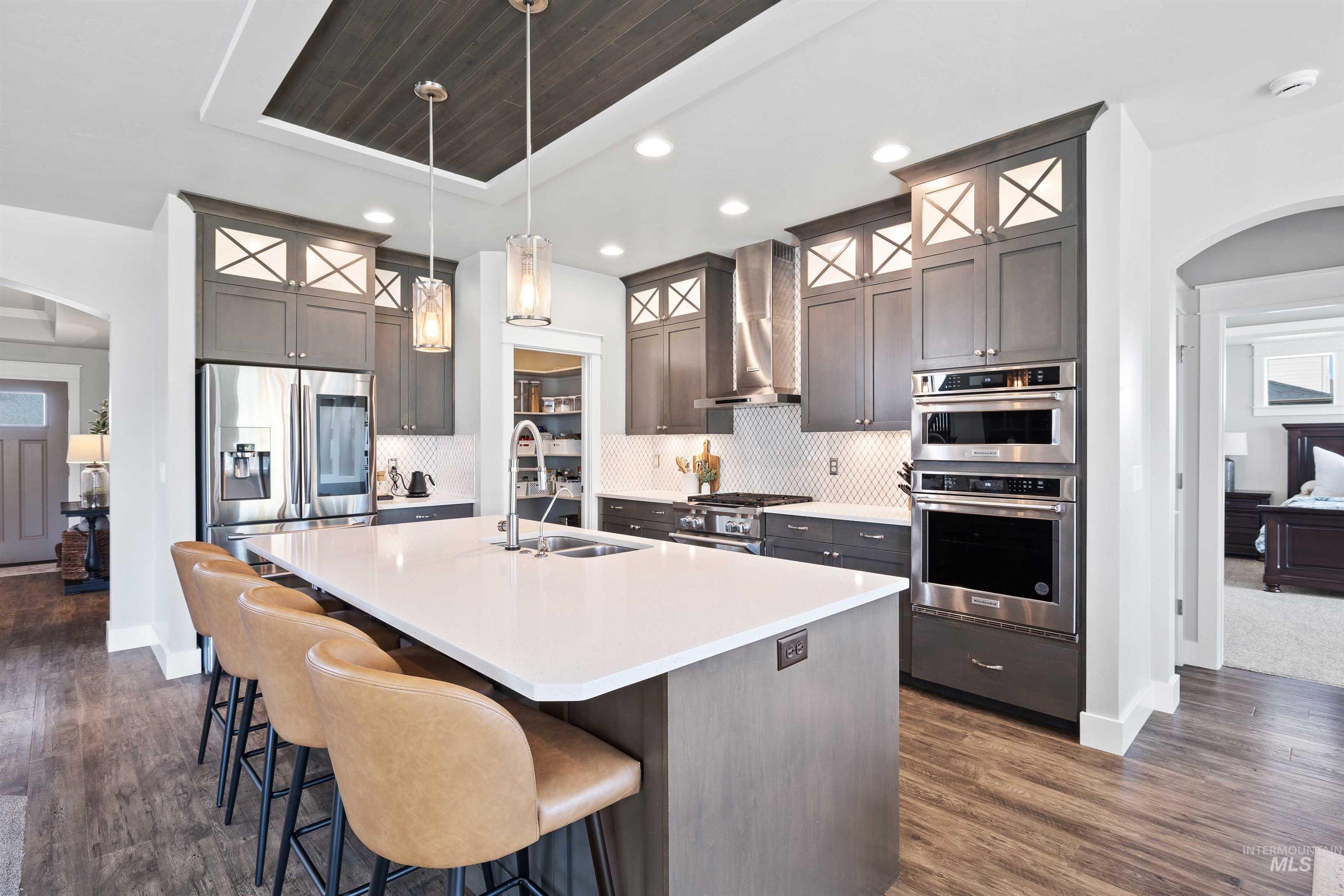 2441 Blick Lane Twin Falls, ID 83301 - Photo 9 of 50 Kitchen featuring a central island with white countertop, recessed lighting, and stainless steel appliances including a double oven and built-in refrigerator