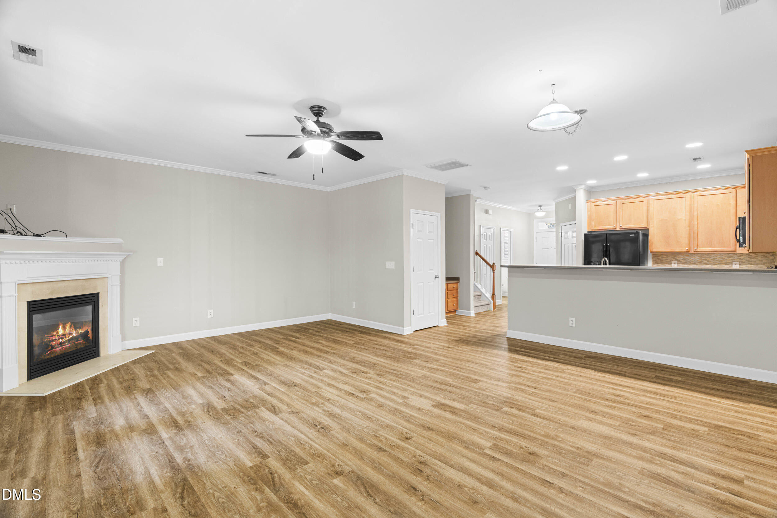 2522 Spring Oaks Way Raleigh, NC 27614 - Photo 12 of 30 a view of an empty room with kitchen and fireplace
