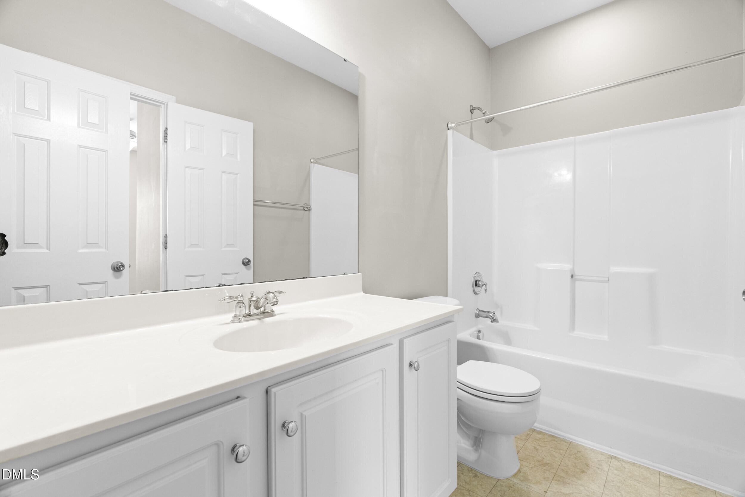 2522 Spring Oaks Way Raleigh, NC 27614 - Photo 24 of 30 a bathroom with a sink a toilet and a large mirror