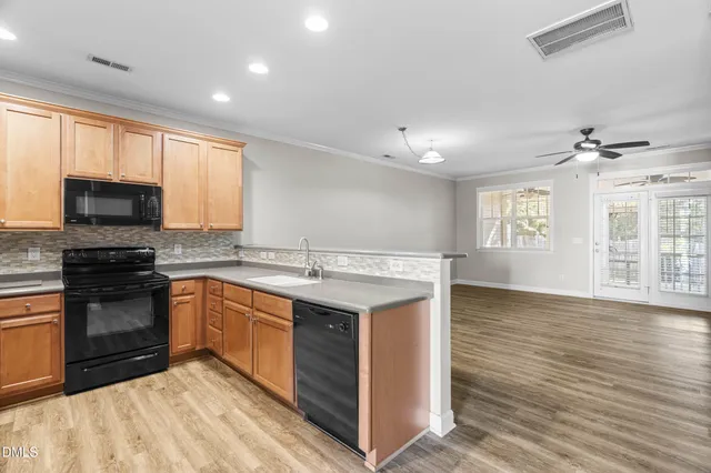 a kitchen with stainless steel appliances granite countertop a sink stove and microwave