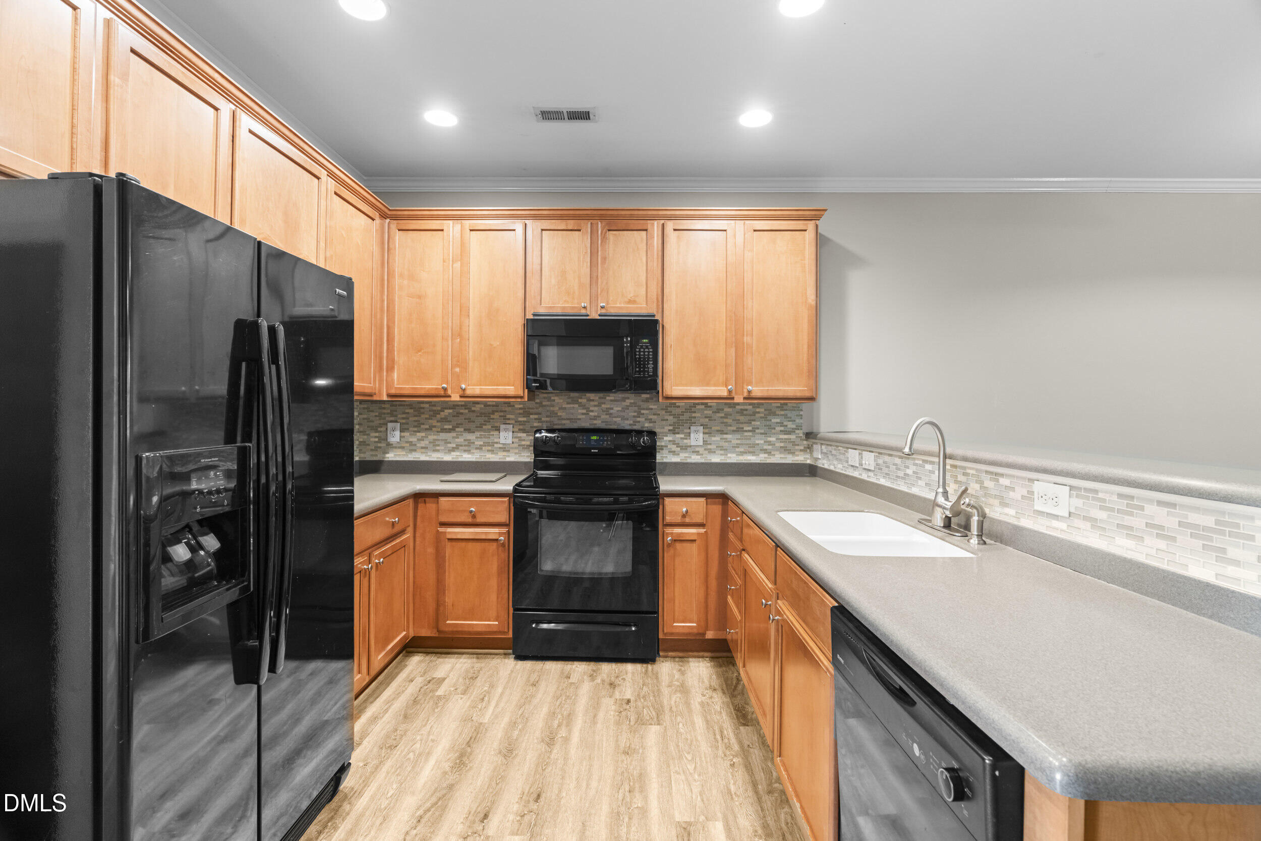 2522 Spring Oaks Way Raleigh, NC 27614 - Photo 7 of 30 a kitchen with stainless steel appliances granite countertop a refrigerator a sink a stove a microwave and island