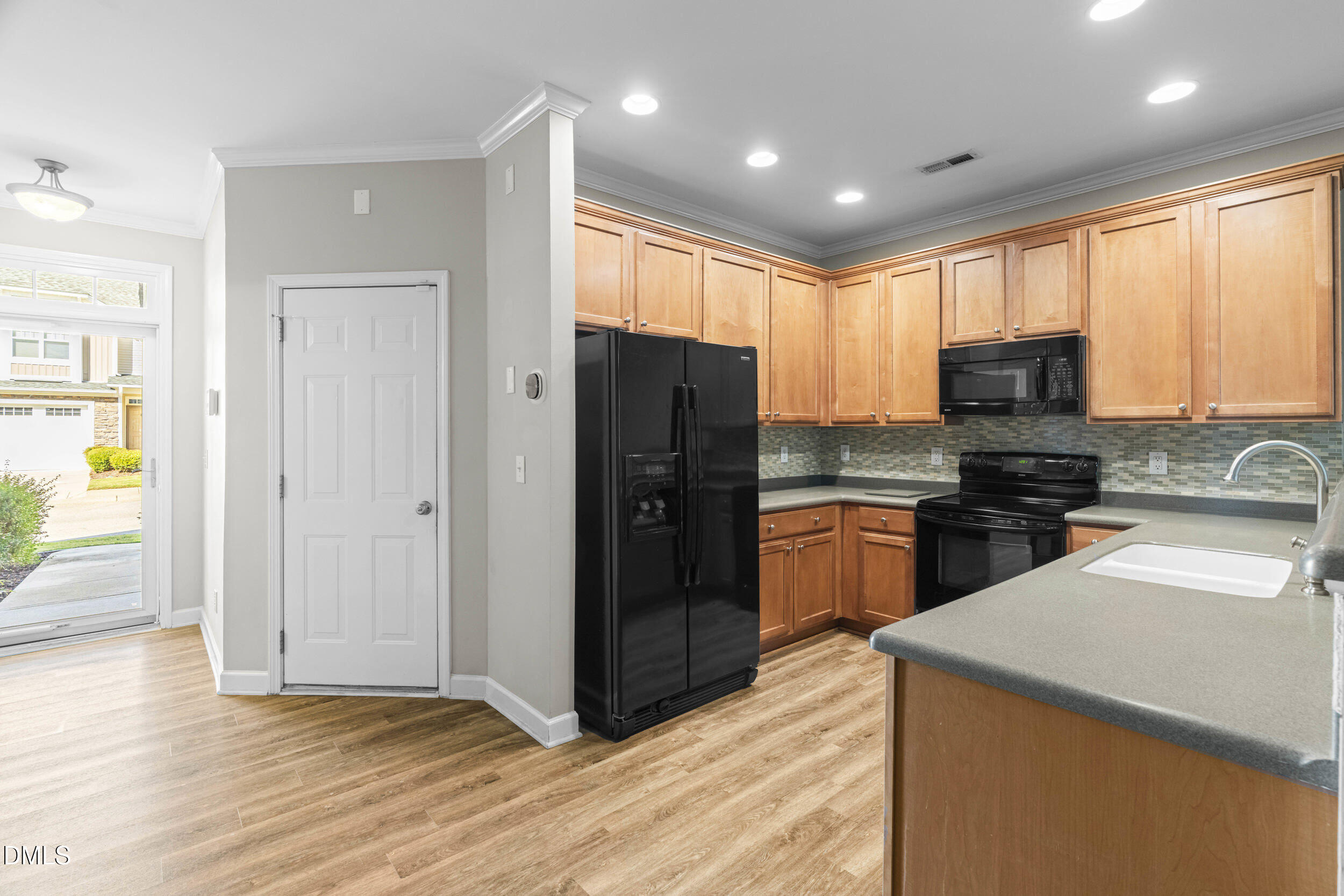 2522 Spring Oaks Way Raleigh, NC 27614 - Photo 8 of 30 a kitchen with granite countertop stainless steel appliances a refrigerator cabinets and wooden floor