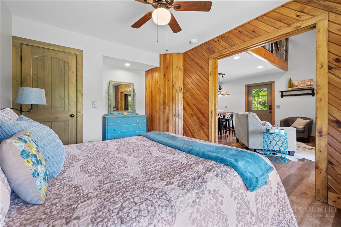 634-636 Watauga River Road Sugar Grove, NC 28679 - Photo 16 of 50 a bedroom with a bed and a chandelier