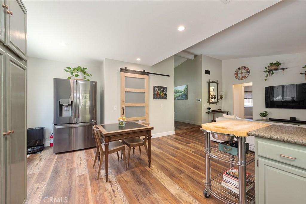 4384 Mill Valley Road Moorpark, CA 93021 - Photo 15 of 32 a room with a table chairs and refrigerator