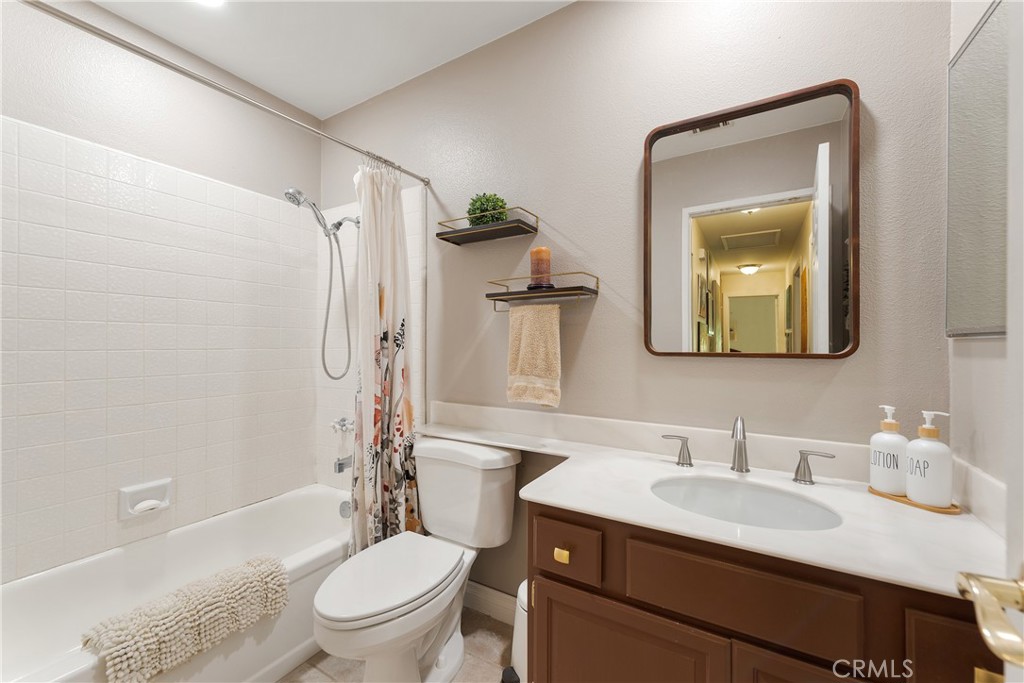4384 Mill Valley Road Moorpark, CA 93021 - Photo 18 of 32 a bathroom with a granite countertop sink toilet and mirror