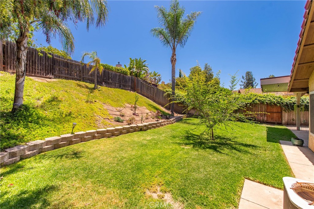 4384 Mill Valley Road Moorpark, CA 93021 - Photo 30 of 32 a view of a swimming pool with a lawn chairs under palm trees