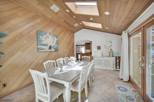 a view of a dining room with furniture and a chandelier