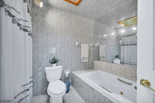 a white bath tub sitting next to a white toilet