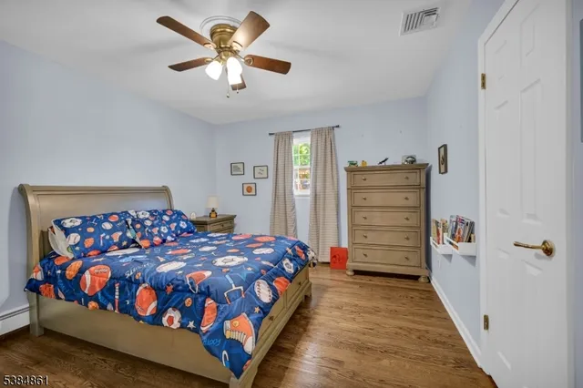 a bedroom with a bed closet and dresser