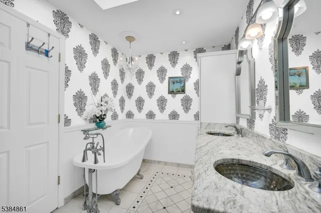 a bath tub sitting in a bathroom next to a sink