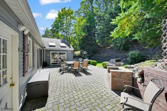 a view of a patio with table and chairs and potted plants