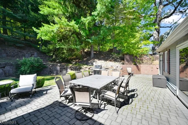 a view of a patio with table and chairs and potted plants