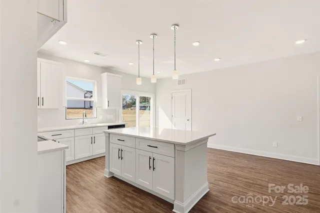a large white kitchen with a large window