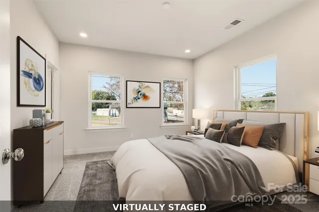 a bedroom with a large bed and a window