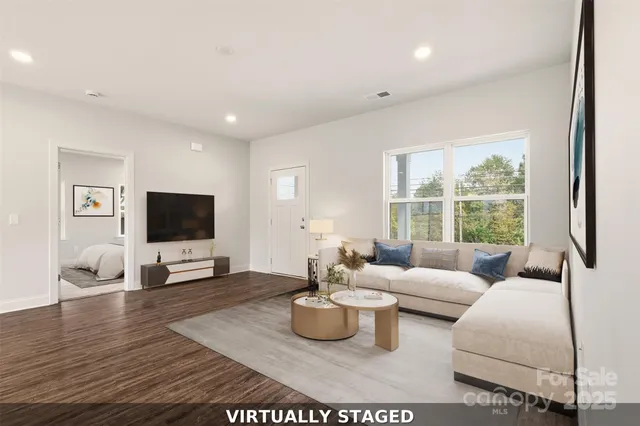 a living room with furniture window and a flat screen tv