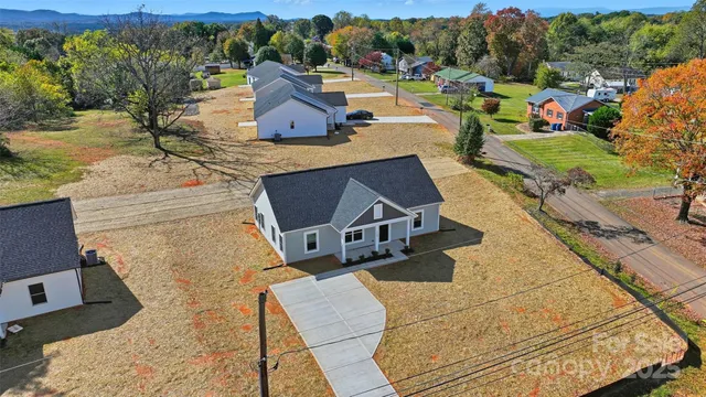 an aerial view of a house with yard swimming pool and outdoor seating