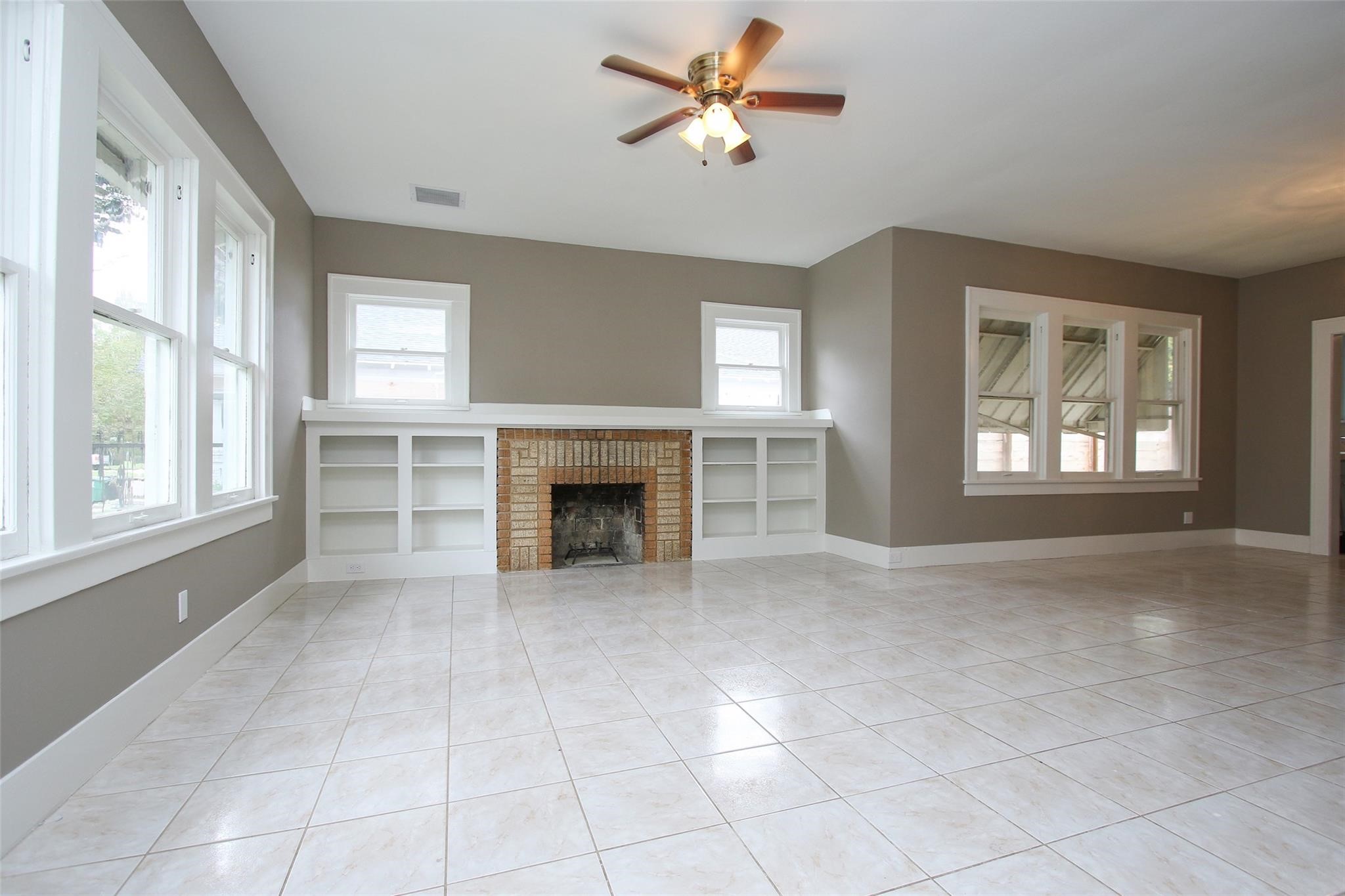 1127 Walling Street Houston, TX 77009 - Photo 2 of 23 a view of an empty room with a fireplace and a window