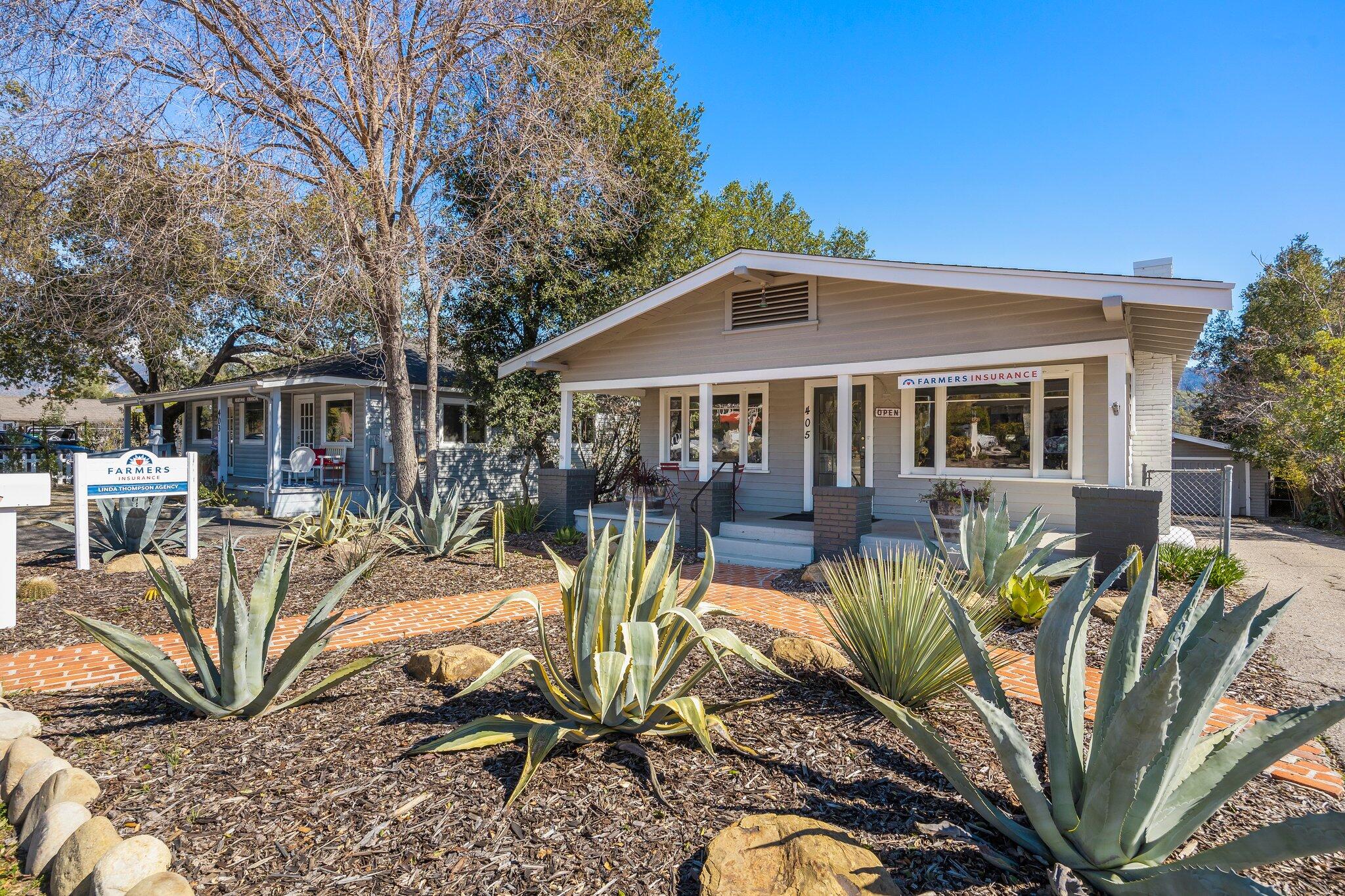405 West Ojai Avenue Ojai, CA 93023 - Photo 2 of 21 a view of a patio with couches table and chairs under an umbrella with large trees