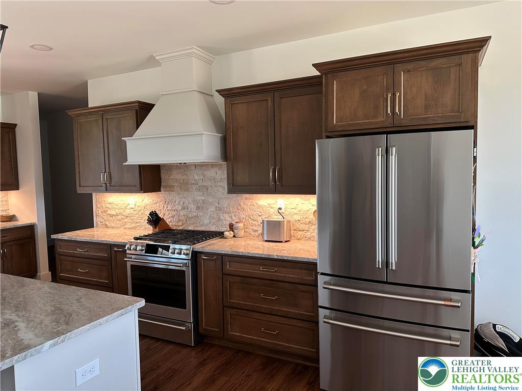 1225 Quince Road Walnutport, PA 18088 - Photo 42 of 50 a kitchen with stainless steel appliances and wood cabinets