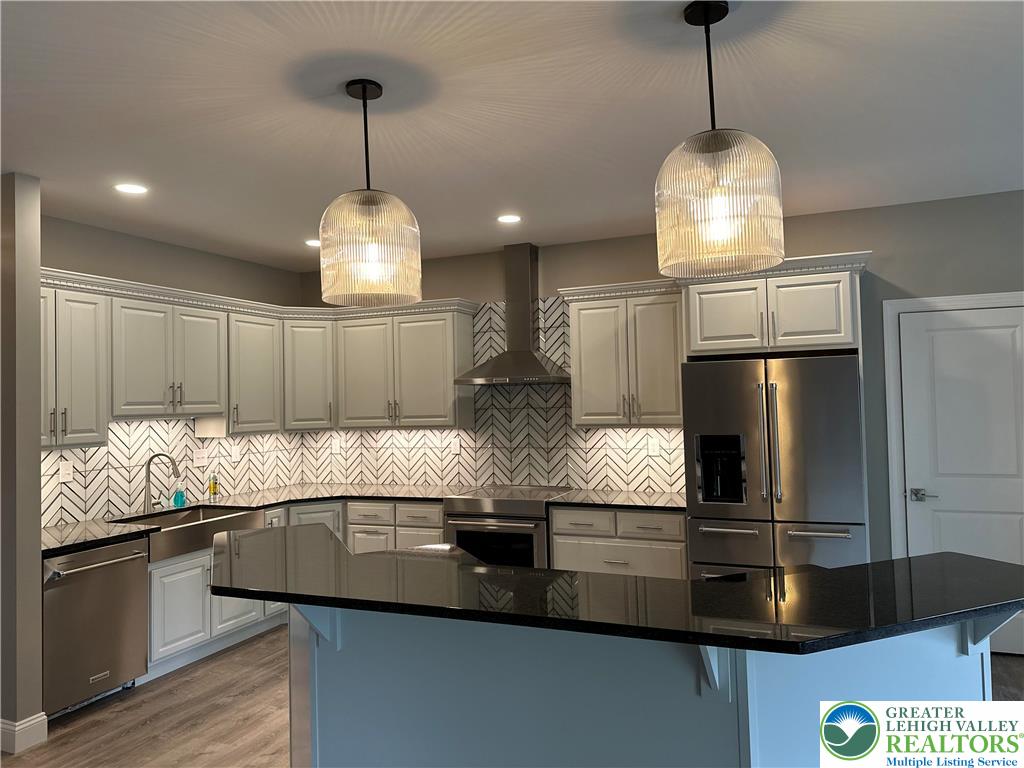 1225 Quince Road Walnutport, PA 18088 - Photo 45 of 50 a kitchen with kitchen island granite countertop stainless steel appliances and a chandelier
