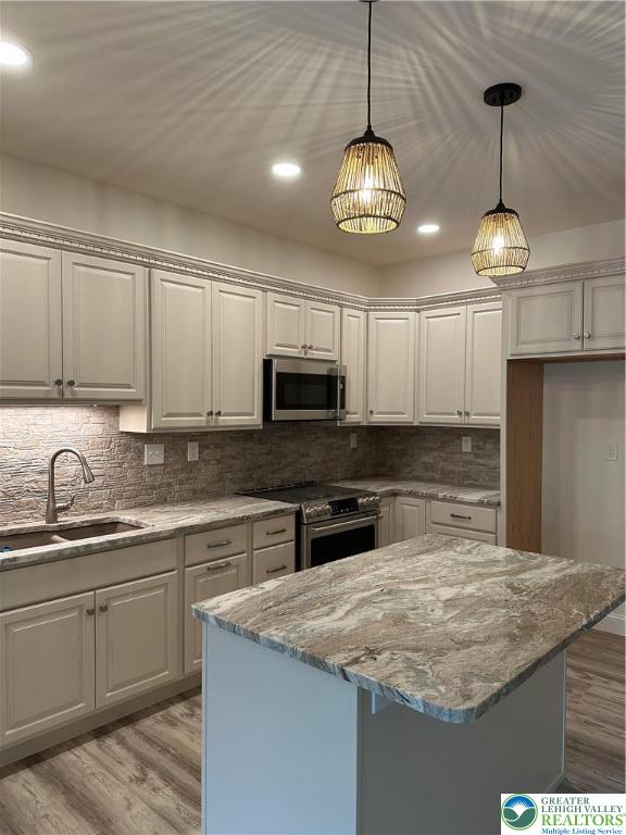 1225 Quince Road Walnutport, PA 18088 - Photo 48 of 50 a kitchen with kitchen island granite countertop stainless steel appliances a sink stove and cabinets