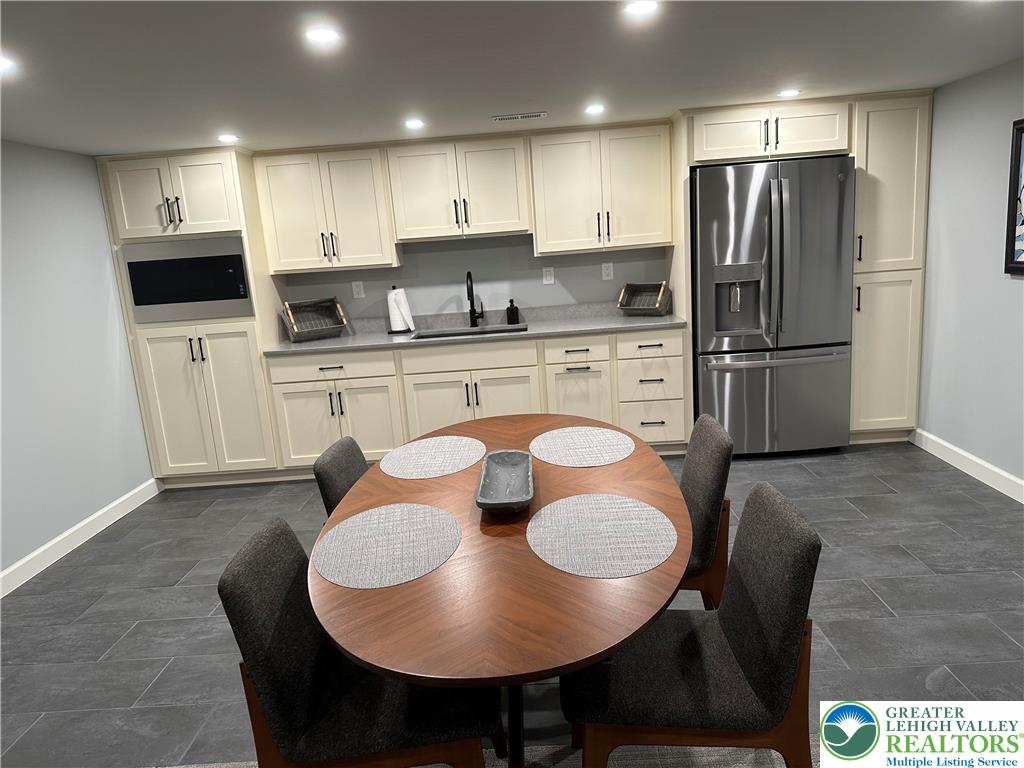 1225 Quince Road Walnutport, PA 18088 - Photo 49 of 50 a kitchen with stainless steel appliances granite countertop a sink a stove a refrigerator and white cabinets