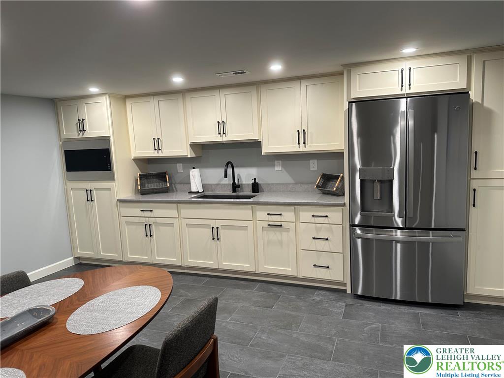 1225 Quince Road Walnutport, PA 18088 - Photo 50 of 50 a kitchen with white cabinets stainless steel appliances and kitchen island