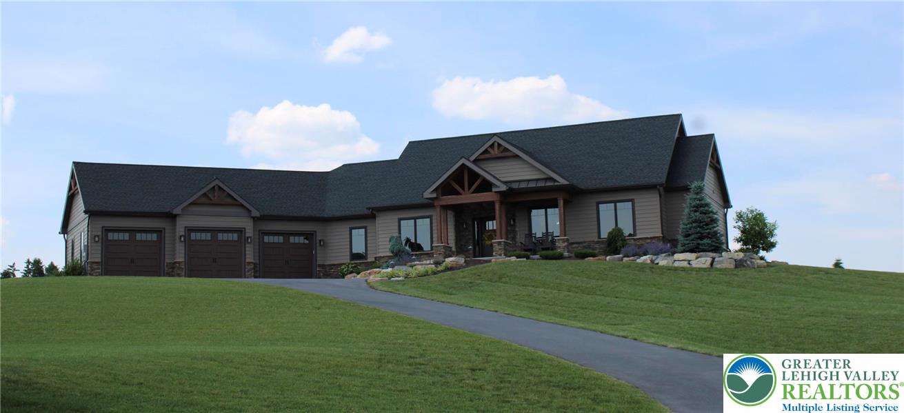 1225 Quince Road Walnutport, PA 18088 - Photo 9 of 50 a front view of a house with a garden