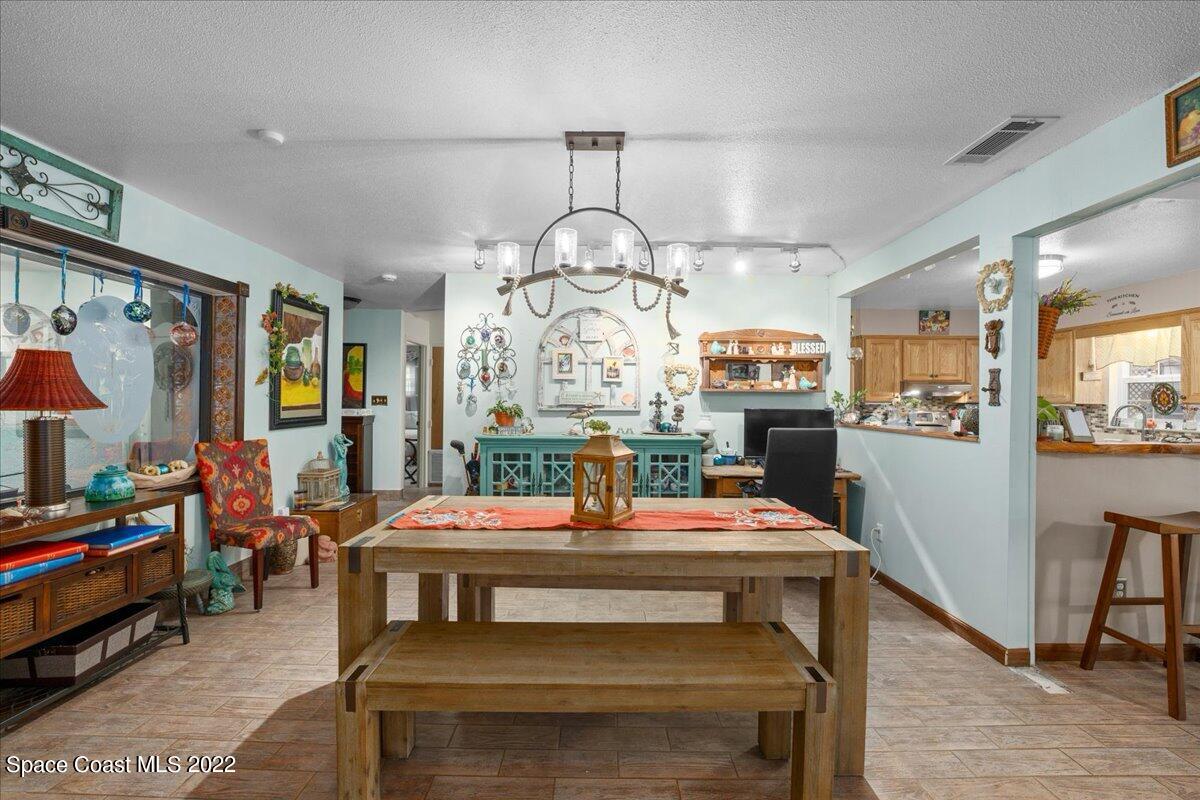 960 Kings Post Road Rockledge, FL 32955 - Photo 11 of 39 a view of a dining room with furniture window and wooden floor