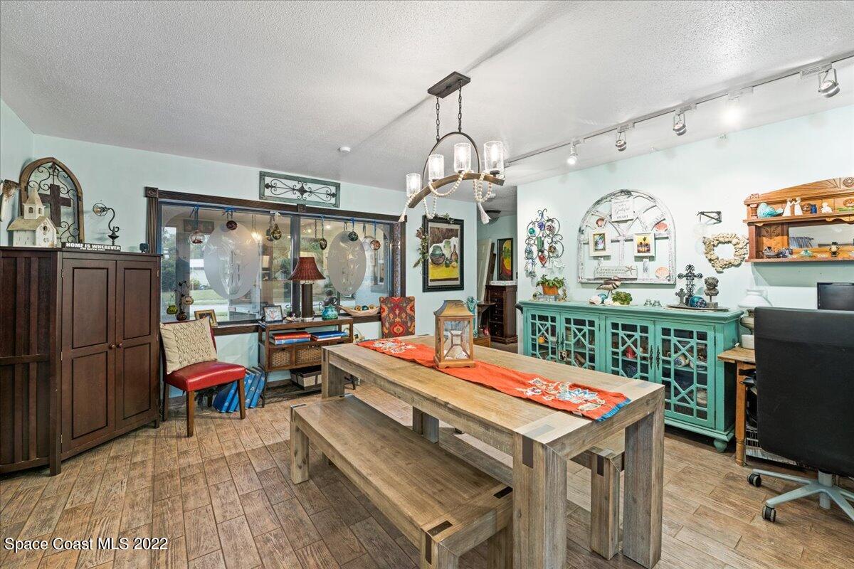 960 Kings Post Road Rockledge, FL 32955 - Photo 12 of 39 a room with musical instrument pool table furniture wooden floor and windows