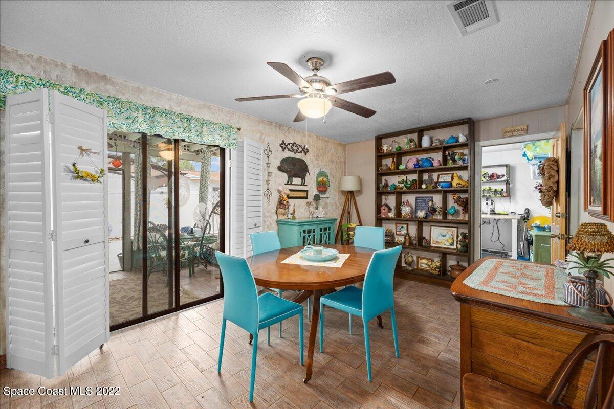 960 Kings Post Road Rockledge, FL 32955 - Photo 13 of 39 a living room with furniture a rug and a bookshelf