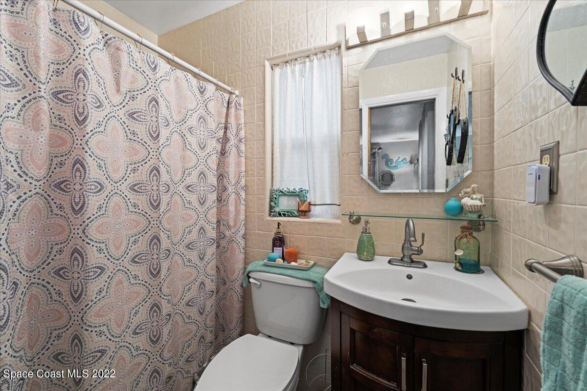 960 Kings Post Road Rockledge, FL 32955 - Photo 16 of 39 a bathroom with a toilet sink and mirror