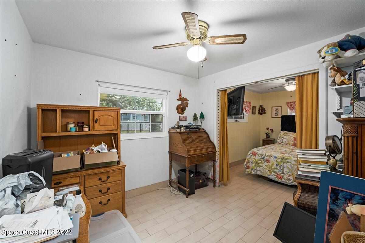 960 Kings Post Road Rockledge, FL 32955 - Photo 17 of 39 a bedroom with furniture and a large window