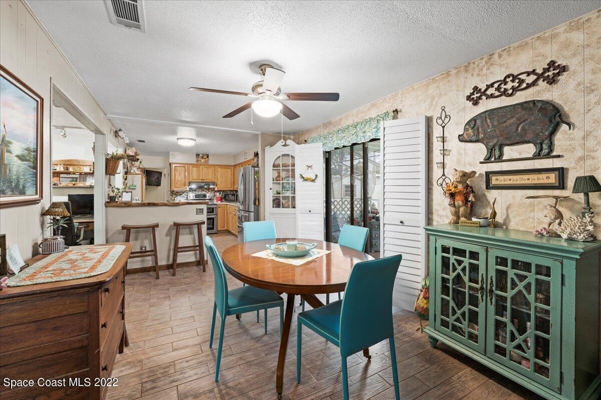 960 Kings Post Road Rockledge, FL 32955 - Photo 22 of 39 a view of a dining room with furniture and wooden floor