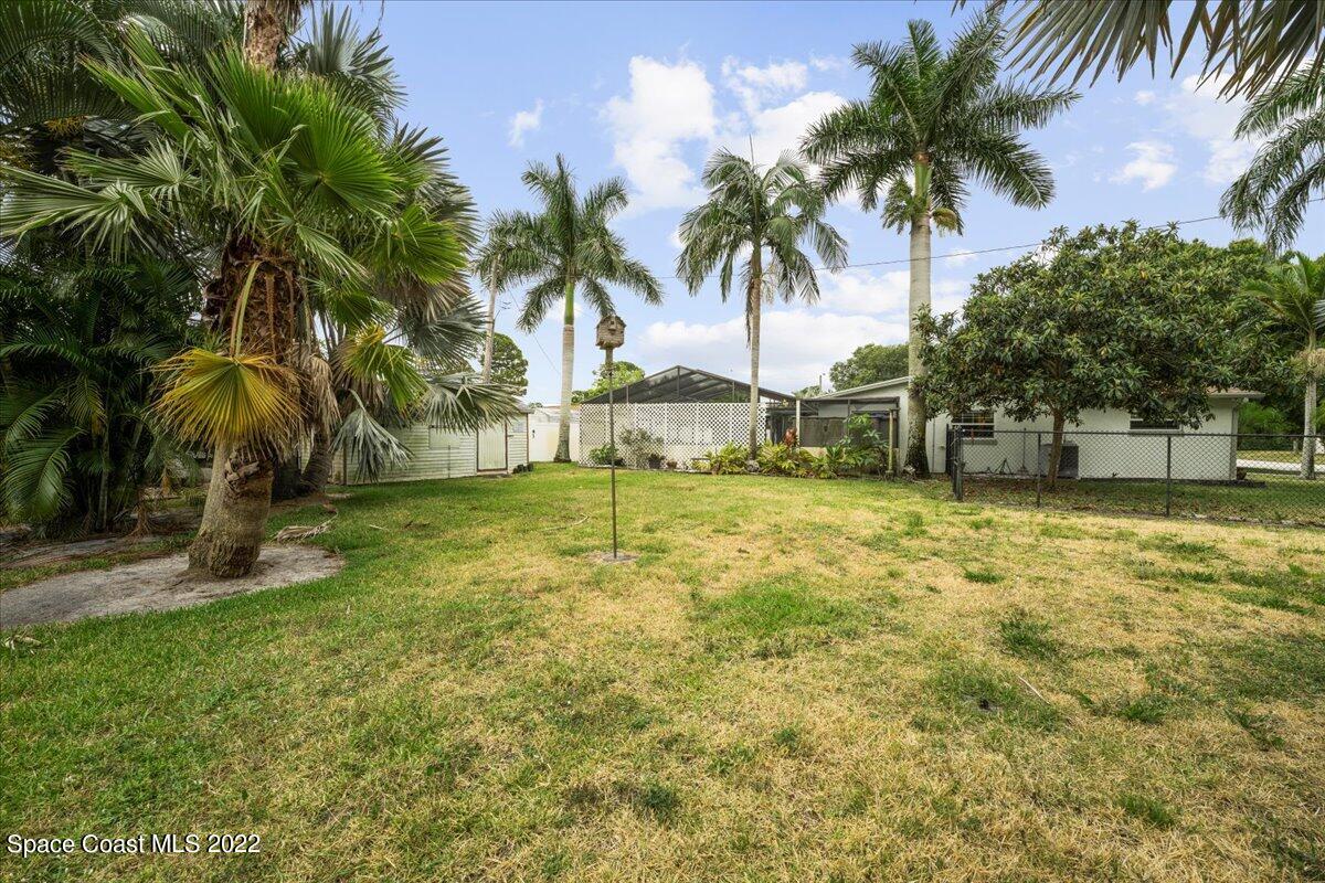 960 Kings Post Road Rockledge, FL 32955 - Photo 29 of 39 a backyard of a house with palm trees