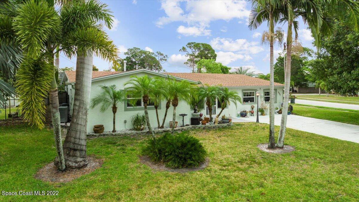 960 Kings Post Road Rockledge, FL 32955 - Photo 3 of 39 a view of a patio with table and chairs potted plants and palm trees