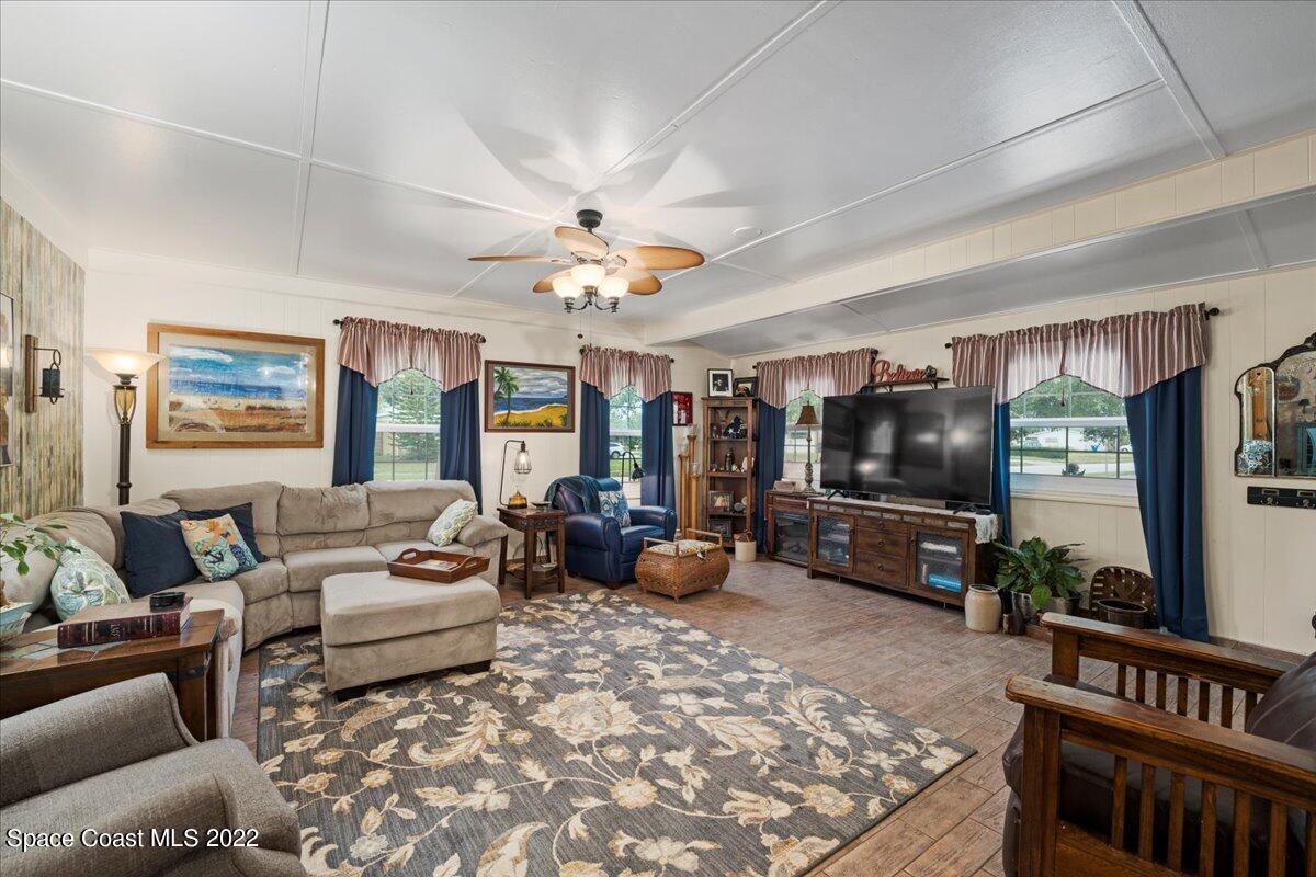 960 Kings Post Road Rockledge, FL 32955 - Photo 5 of 39 a living room with furniture and a flat screen tv